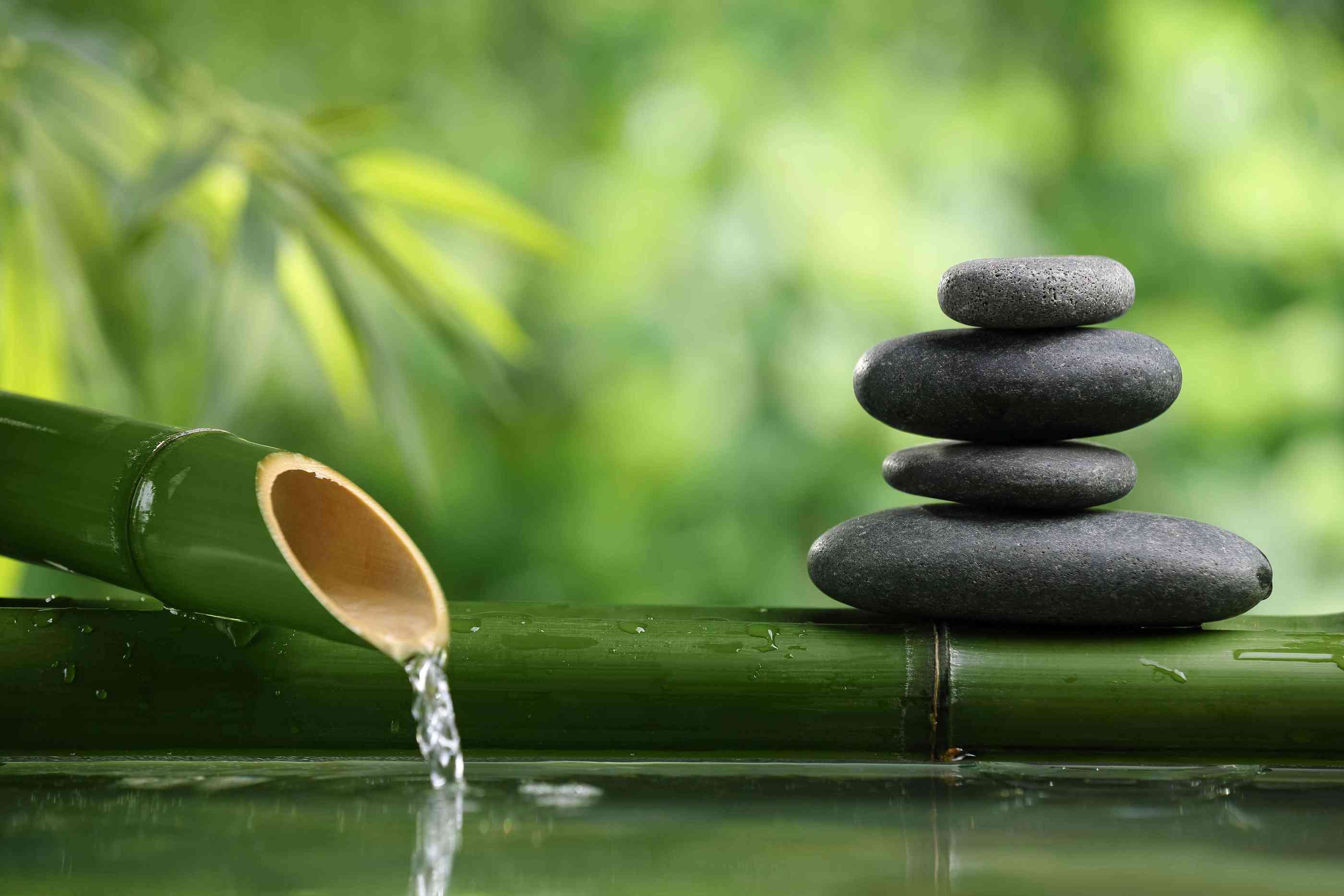 Zen bamboo fountain with stacked stones